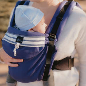 Neo de Neobulle, le porte bébé dès la naissance. Portage physiologique pour papa et maman. Permet un portage dos et devant en sécurité, la position naturelle du bébé est maintenue. Achat en Suisse chez JeTePorte à Fribourg